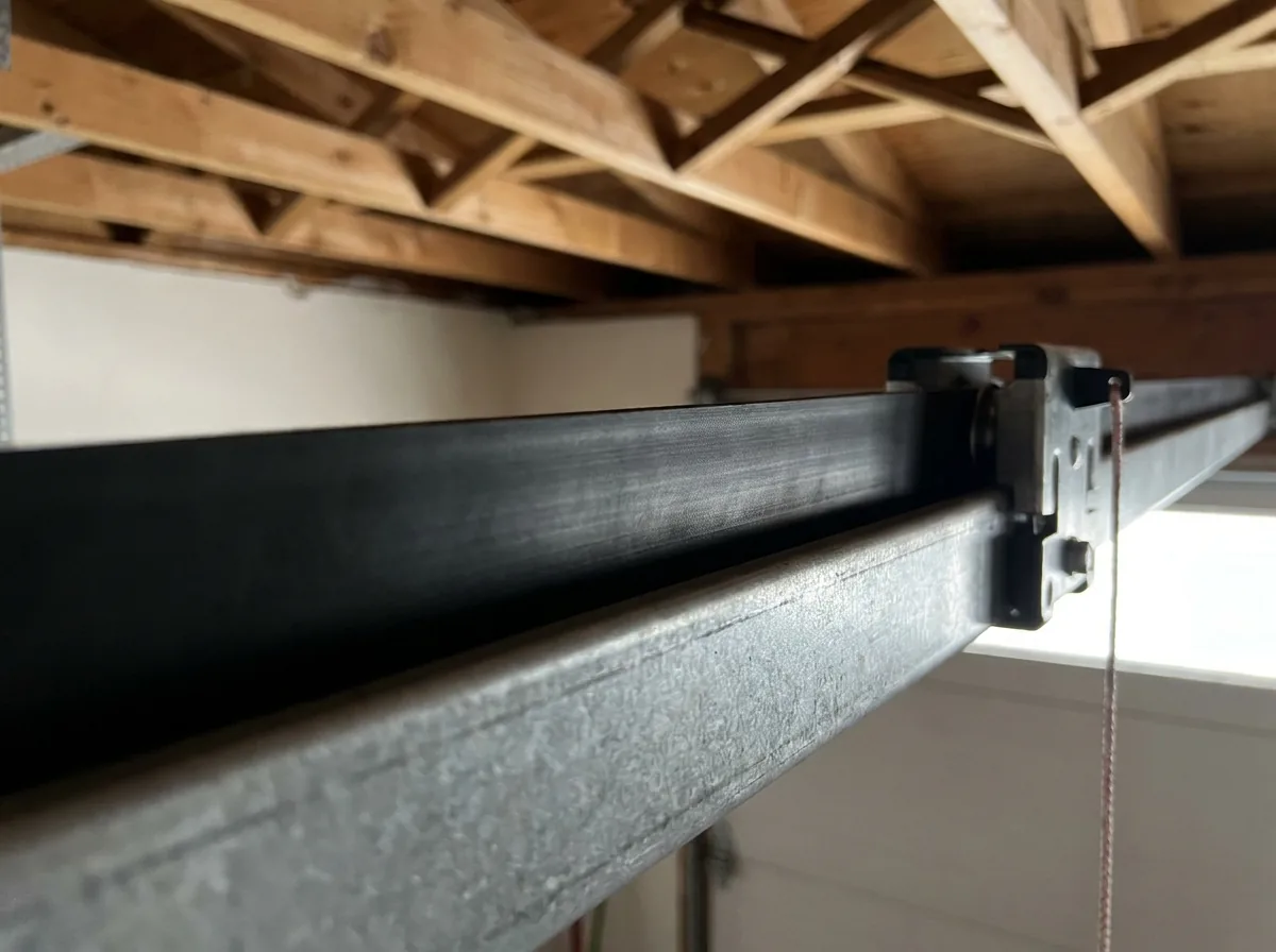 Wide reinforced rubber belt running along an opener rail to the trolley, with no chain links anywhere